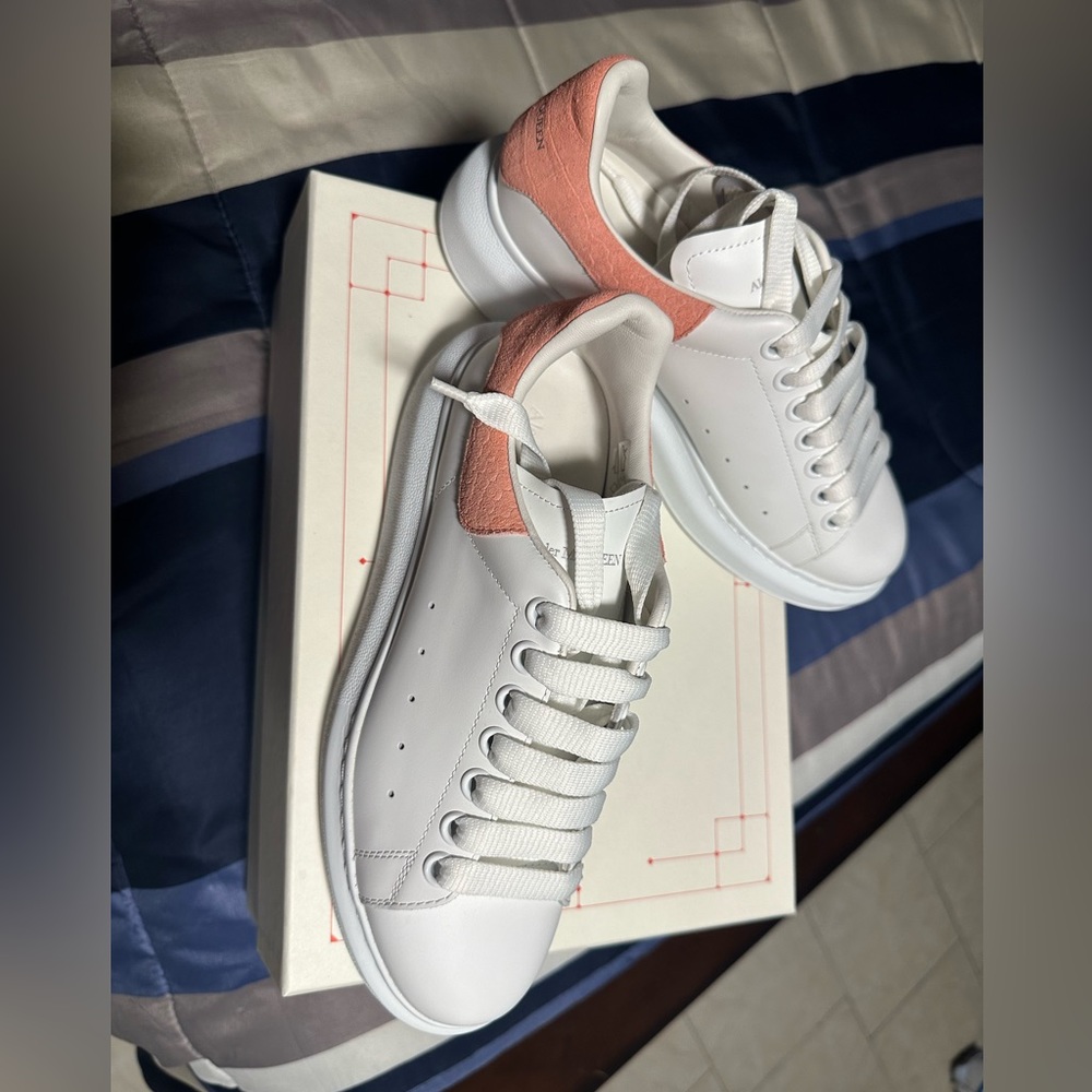 This is a size 38.5 white with peach Alexander McQueen sneakers